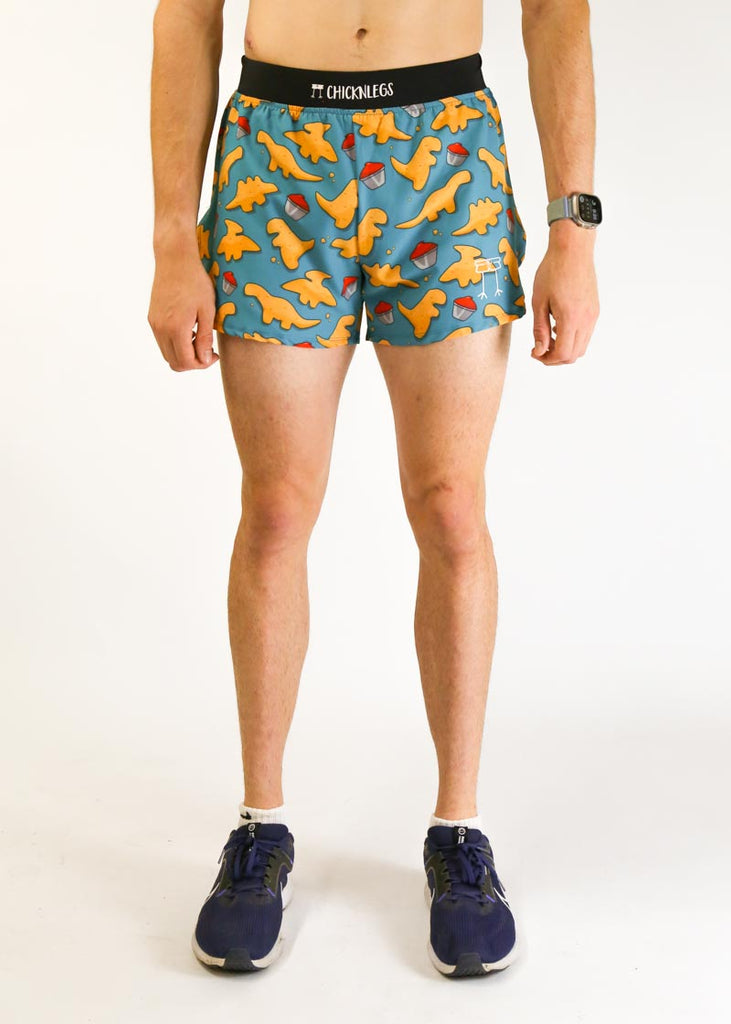 Model wearing chicknlegs men's 4 inch split running shorts in the dino nugget design facing front