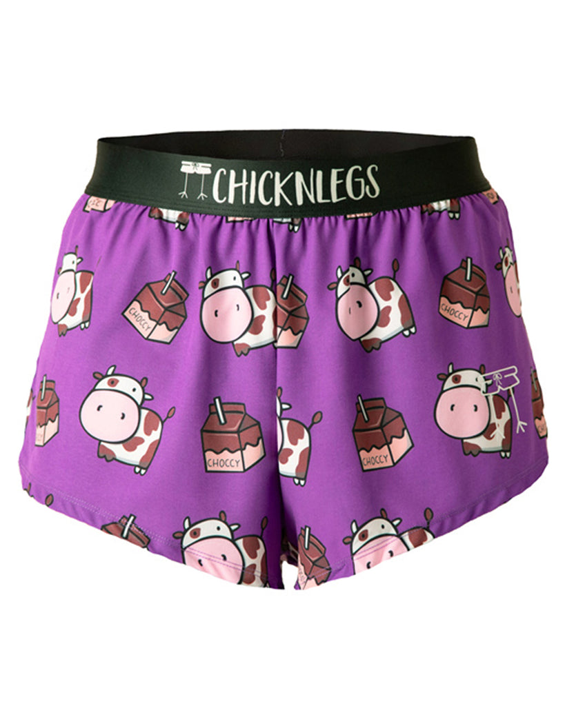 These chicknlegs shorts are the men's 2 in split running shorts in the choccy cow design, as a ghost image. The print has brown cows on it with chocolate milk on it and a purple background.