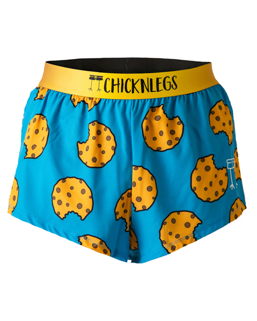 These chicknlegs are in the men's 2 in split running shorts in the cookies design, as a ghost image. The print has cookies on it on a blue background and yellow waistband.