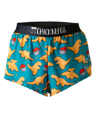 These chicknlegs shorts are the men's 2 in split running shorts in the dino nugget design, as a ghost image. The print has a blue background with dinosaur chicken nuggets on it with ketchup, made for runners.