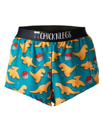 These chicknlegs shorts are the men's 2 in split running shorts in the dino nugget design, as a ghost image. The print has a blue background with dinosaur chicken nuggets on it with ketchup, made for runners.