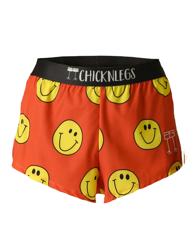 These shorts are from chicknlegs in the men's 2 in split running shorts s the smiley design, as a ghost image. These shorts are made for runners with a lot of smiley faces all over with an orange background.