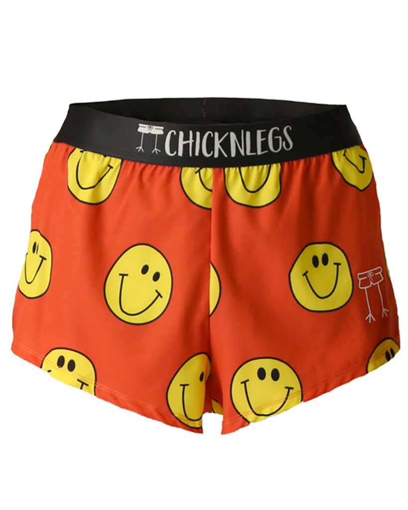 These shorts are from chicknlegs in the men's 2 in split running shorts s the smiley design, as a ghost image. These shorts are made for runners with a lot of smiley faces all over with an orange background.