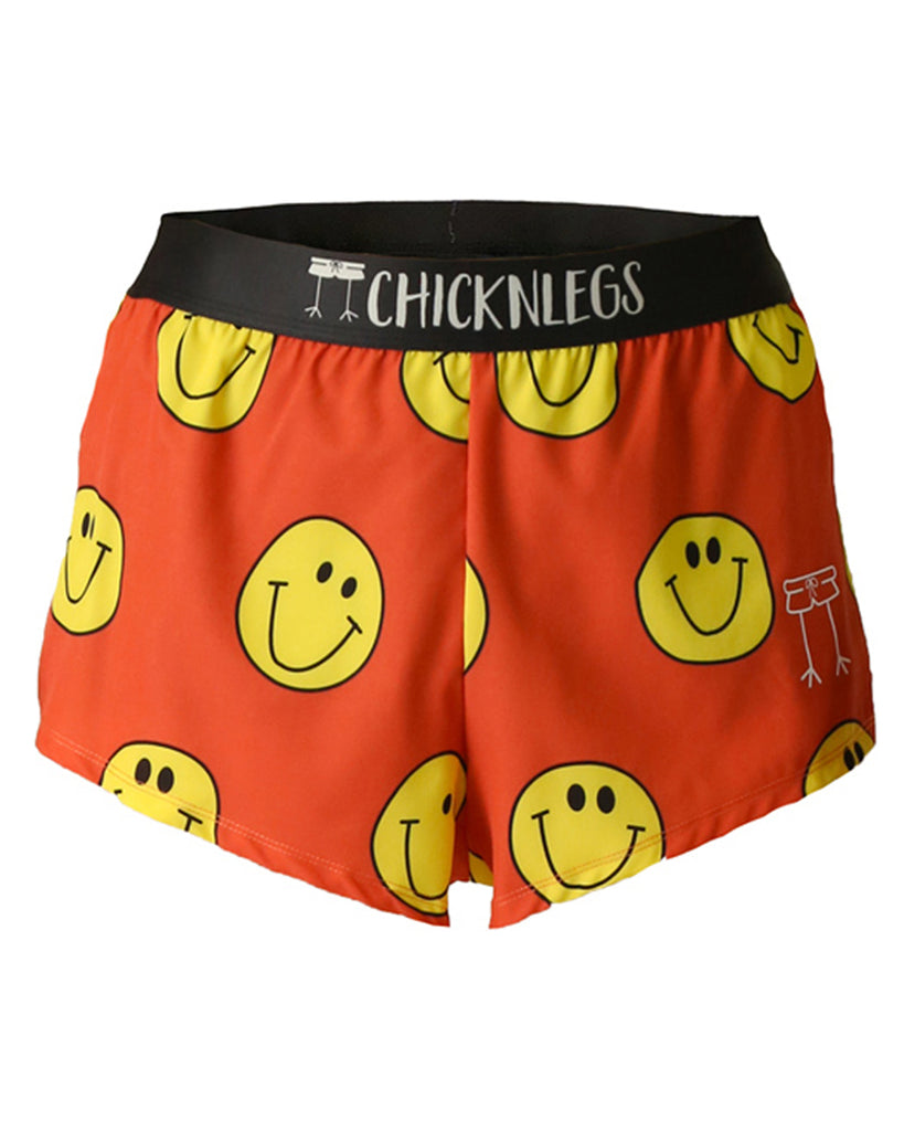 These shorts are from chicknlegs in the men's 2 in split running shorts s the smiley design, as a ghost image. These shorts are made for runners with a lot of smiley faces all over with an orange background.