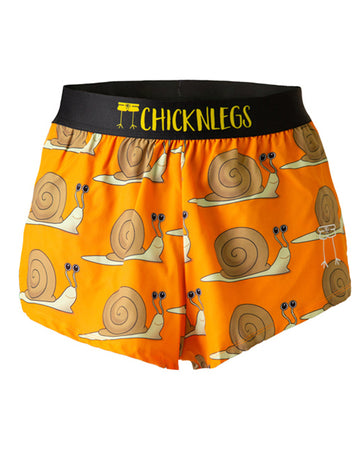 Ghost image of ChicknLegs men's 2 in split running shorts with the snail print on it. The design has brown snails on an orange background.