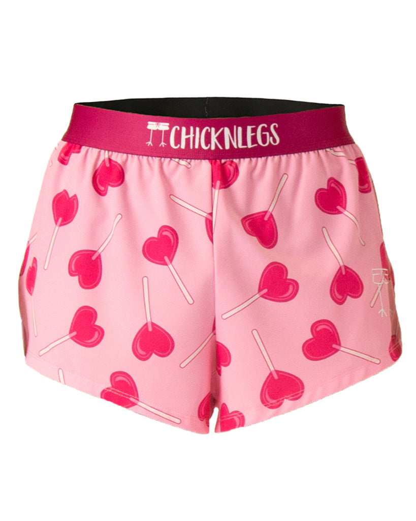 These shorts are from Chicknlegs that are the men's 2 in split running shorts with the luvpop design on it. They are for valentines day which is for a holiday that have pink lolipops on it that are hearts. Pink hearts on a light pink background for runners.