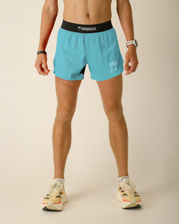 The model is a runner who is wearing Chicknlegs in the men's 4 in split running shorts in the Sky Blue solid color design, facing front.