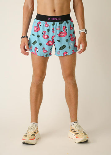 Model wearing Chicknlegs in men's 4 inch split running shorts in the blue flamingo design, facing front.