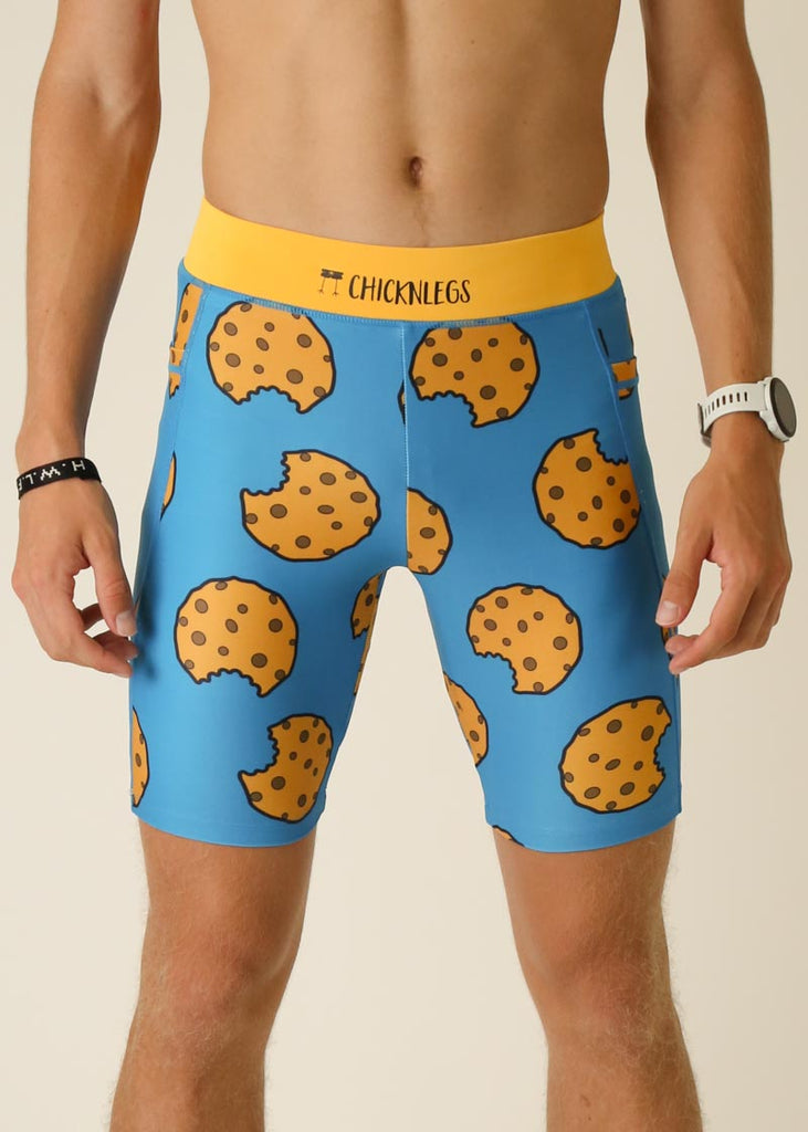 Model wearing Chicknlegs men's 8 inch half tights in the cookies design, close up view.