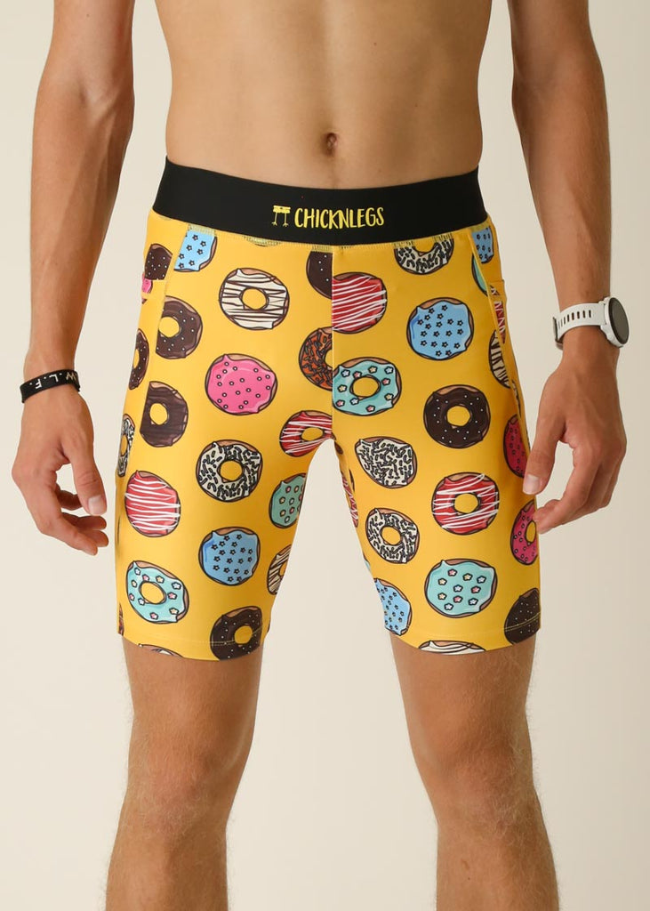 Model wearing Chicknlegs men's 8 inch half tights in the salty donuts design, close up view.