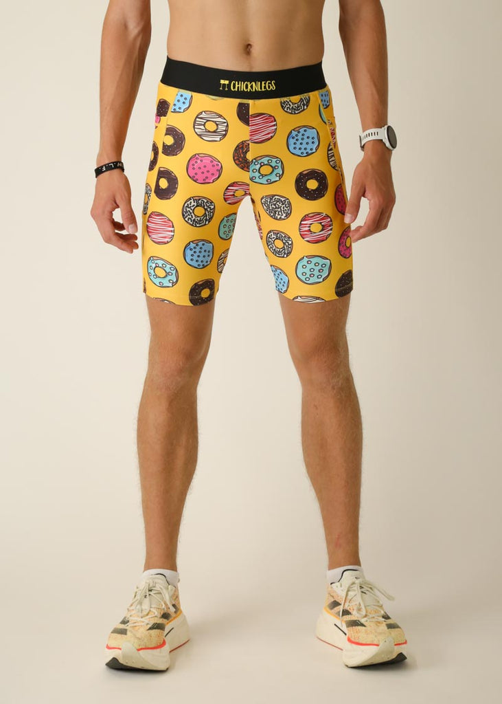 Model wearing Chicknlegs men's 8 inch half tights in the salty donuts design, front view.