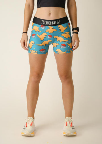 Model is wearing Chicknlegs women's 3 inch compression shorts for running in the dino-nuggets design, facing front.