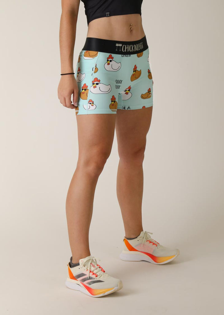 Model is wearing Chicknlegs women's 3 inch compression shorts for running in the swaggy chicken design, facing right for right side view.
