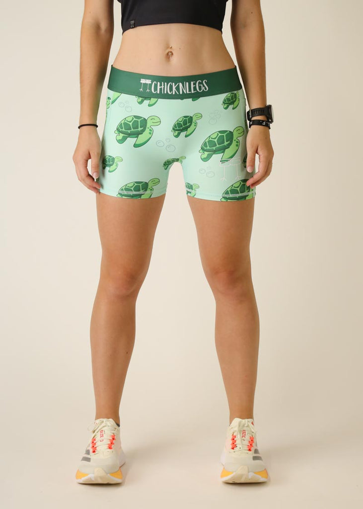 Model is wearing Chicknlegs women's 3 inch compression shorts for running in the turtles design, facing front.