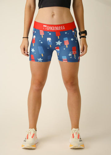 Model is wearing Chicknlegs women's 3 inch compression shorts for running in the usa popsicles design, facing front.