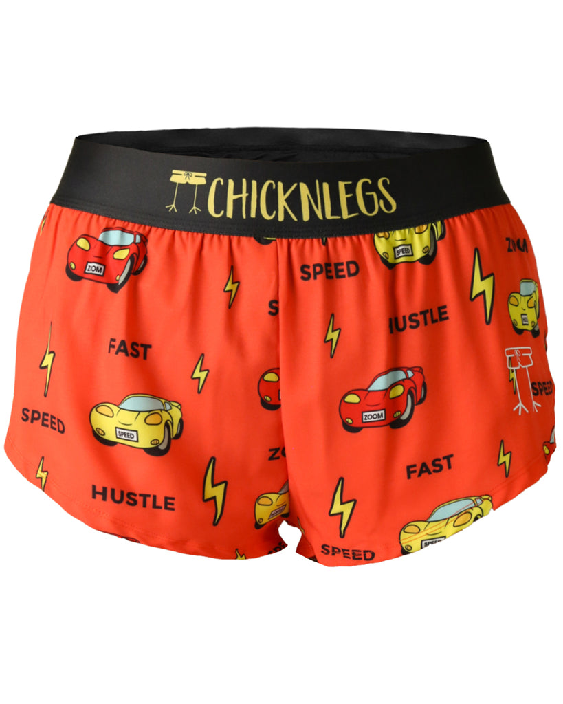 These shorts are from Chicknlegs in the women's 1.5 in split running shorts in the cars design, as a ghost image. The print has red and yellow cars on it with yellow bolts.