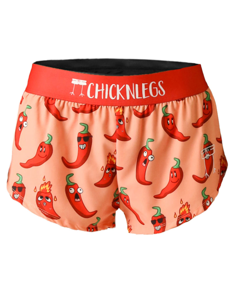 These shorts are from Chicknlegs in the women's 1.5 in split running shorts in the chili pepper design, as a ghost image. The print has fun chili peppers on it with sunglasses and a light orange background.