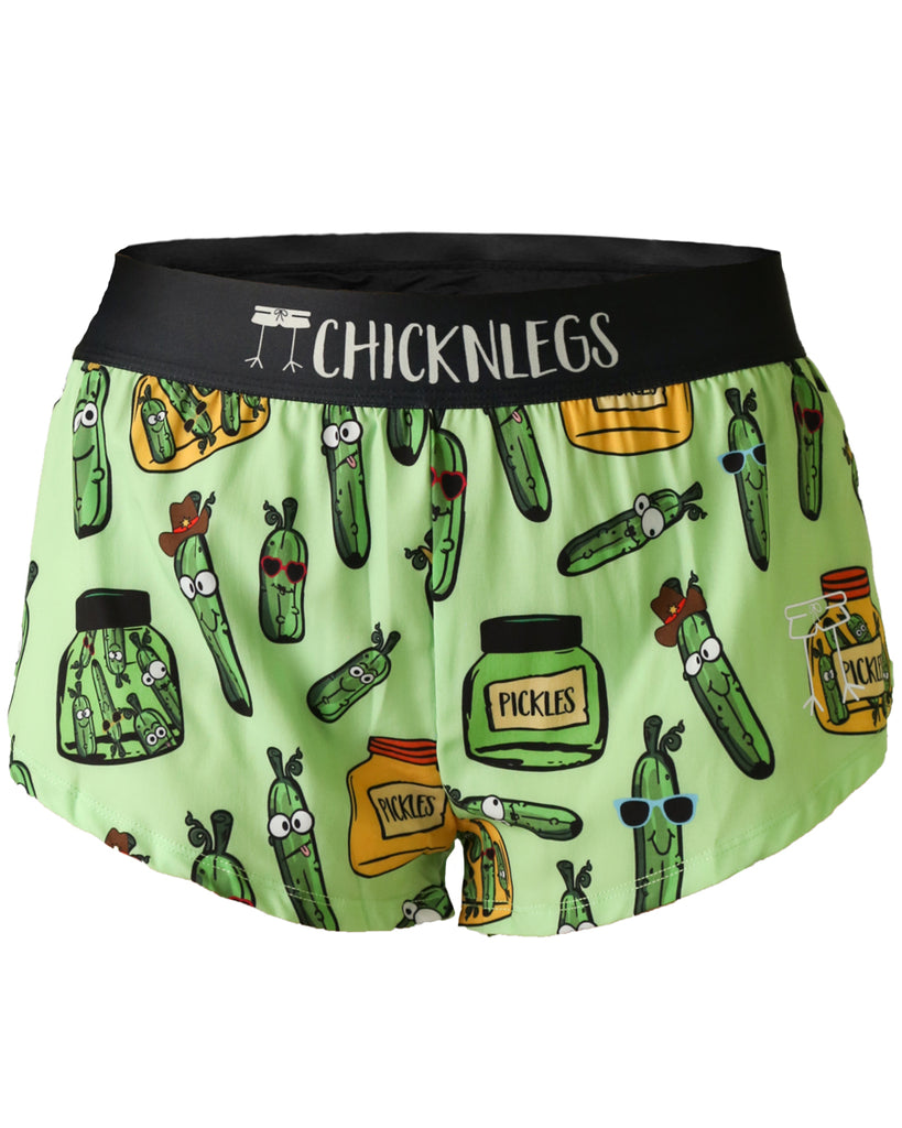 Chicknlegs women's 1.5 in split running shorts in the pickles design, as a ghost image. The print has fun pickles all over it with green and yellow jars.