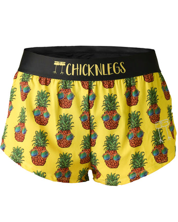 Chicknlegs women's 1.5 in split running shorts in the pineapple express design, as a ghost image. The print has pineapples with sunglasses on a yellow background.