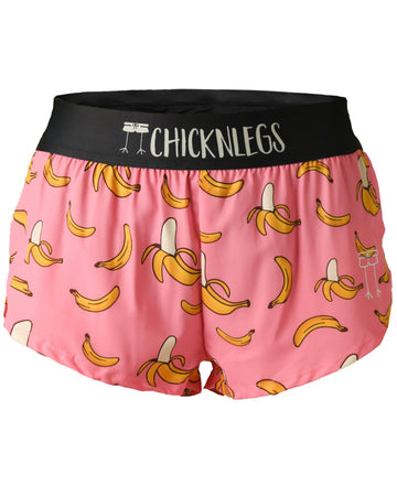 Chicknlegs women's 1.5 in split running shorts in the pink bananas design as a ghost image. The print has fun yellow bananas on it with a light pink background.