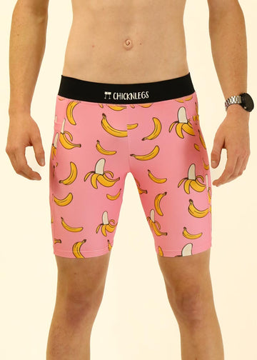 Model wearing Chicknlegs men's 8 inch half tights in the pink bananas design. A close up photo of the half tights is shown.