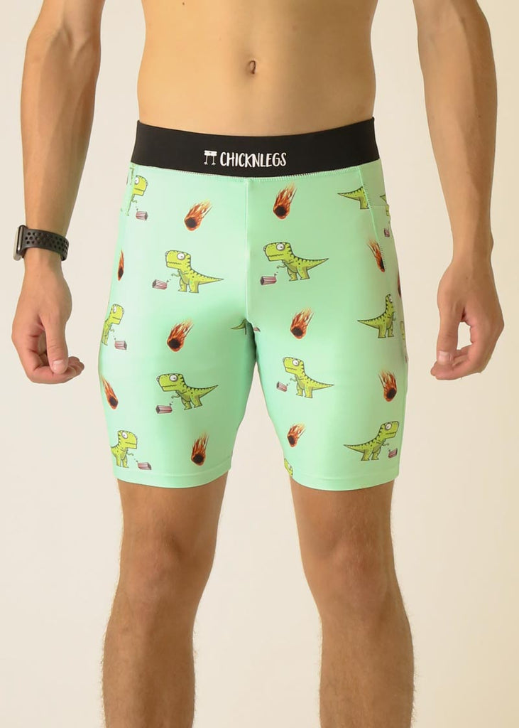 Model wearing Chicknlegs in men's 8 inch half tight in the dino's design facing front. A close up shot of the model is shown of the half tights.