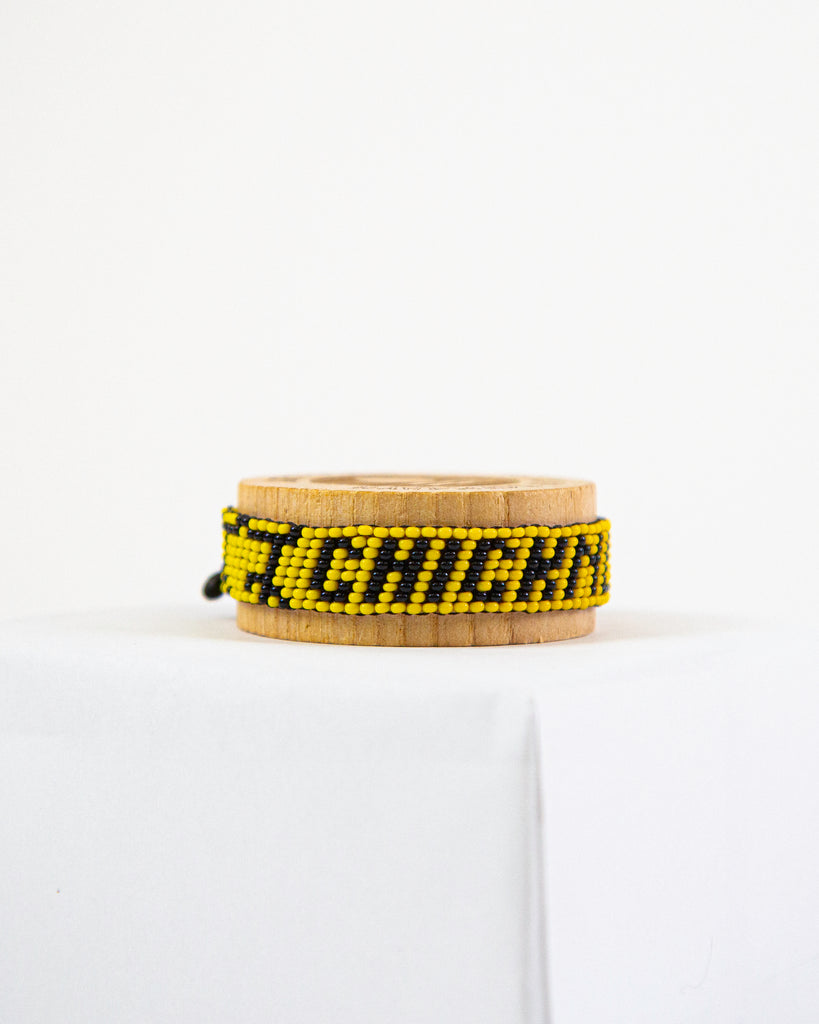 ChicknLegs artiken bracelet made with yellow and black beads. Great accessory for running and wearing with everyday clothes.