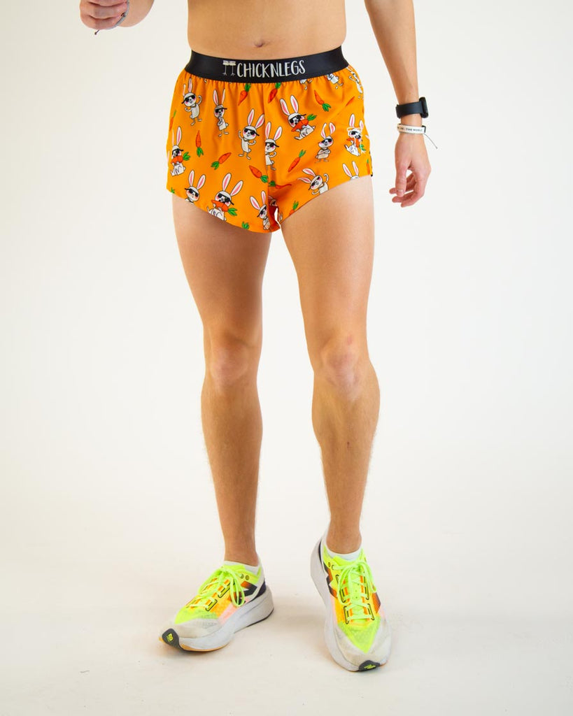 Runner is wearing ChicknLegs in the men's 2 in split running shorts with the bad bunny design. The print has white rabbits on it with sunglasses and carrots.