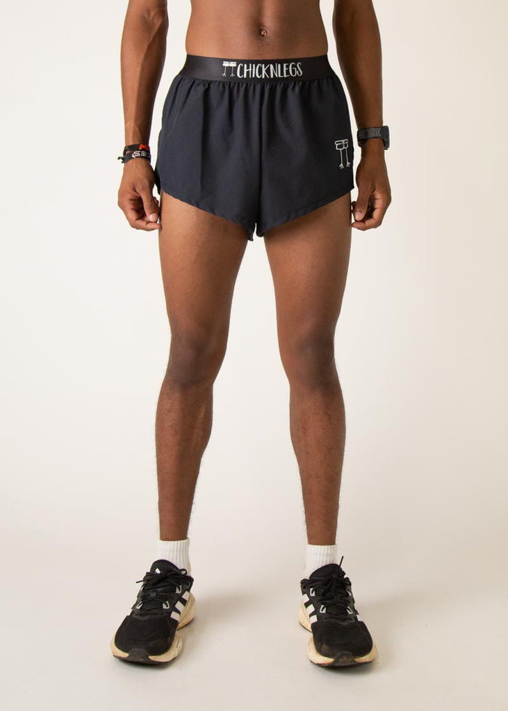 Model is wearing Chicknlegs in the mens 2 inch split running shorts in the black design, facing front.