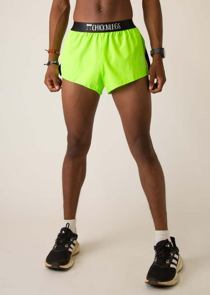 Model wearing Chicknleg's mens 2 inch split running shorts in the neon green design, facing front.