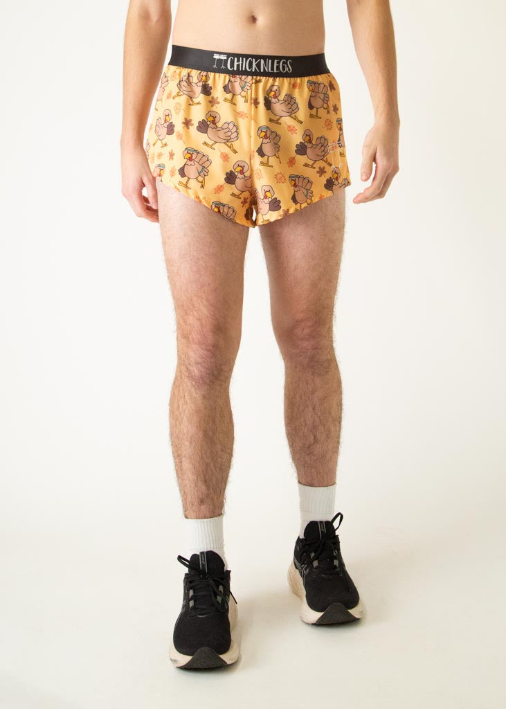 The model is a runner who is wearing Chicknlegs in men's 2 inch split running shorts in the pardoned turkey design, facing front.