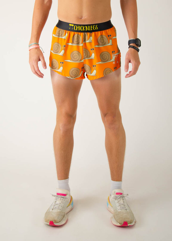 The model is a runner wearing Chicknleg's men's 2 inch split running shorts in the snails design, facing front.
