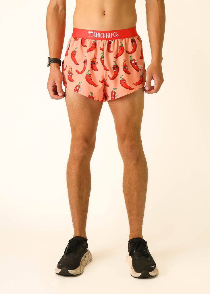 Model is a runner, wearing athletic shorts made by Chicknlegs in the men's 2 inch split running shorts in the chase pack chili pepper design, facing front.
