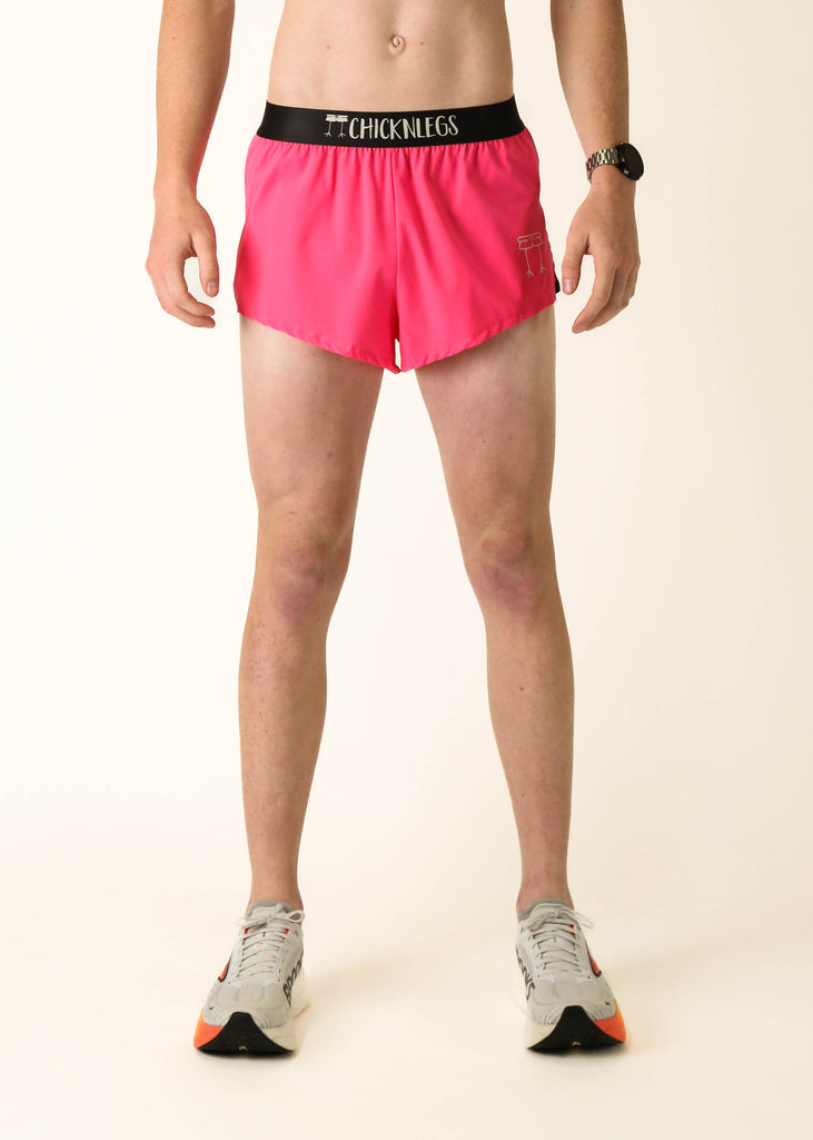 Model wearing Chicknlegs men's 2 inch split running shorts in the neon pink design facing front.
