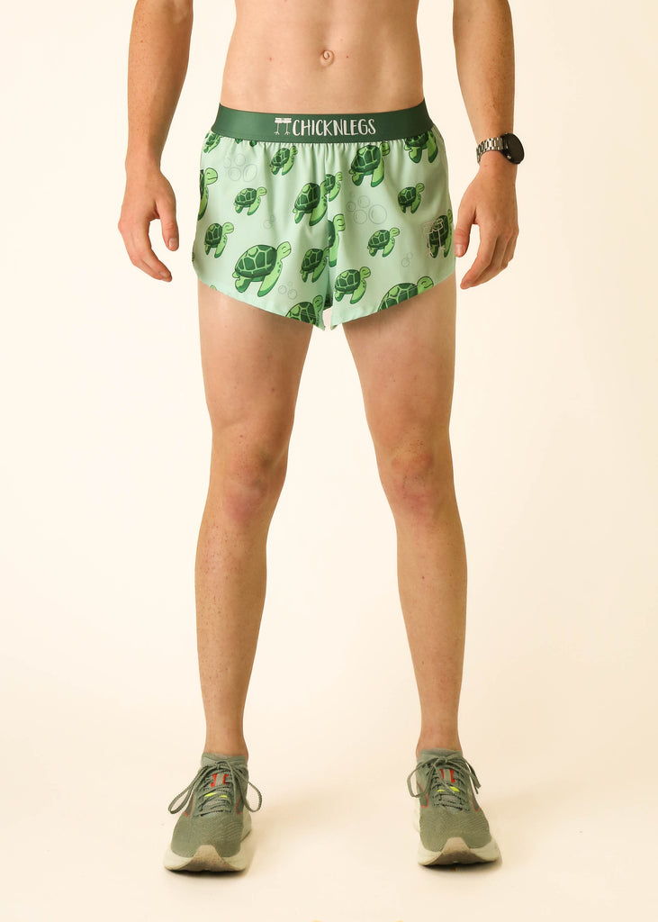 Model wearing Chicknlegs men's 2 inch split running shorts wearing the sea turtles design facing front.
