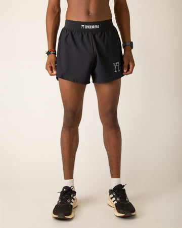 Runner is wearing ChicknLegs in the men's 4 in split running shorts that includes a back pocket and inner pocket in the solid black design.