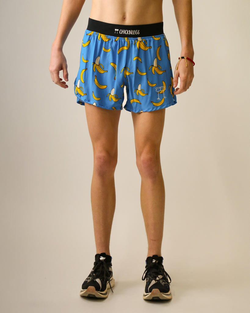 Runner is wearing ChicknLegs in the men's 4 in split running shorts that has a back pocket and inner liner pocket. The print has bananas on a blue background for the design.