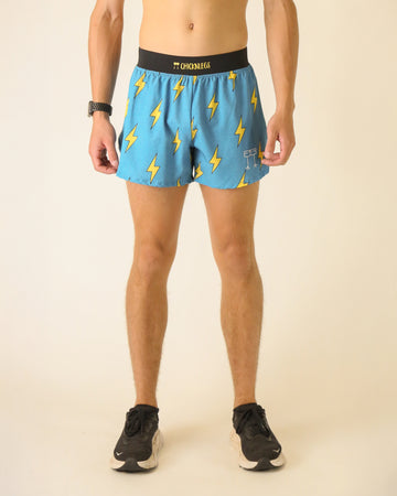 Runner is wearing ChicknLegs in the men's 4 in split running shorts that has a back pocket and inner liner pocket. The print has yellow lightning bolts on a blue background.