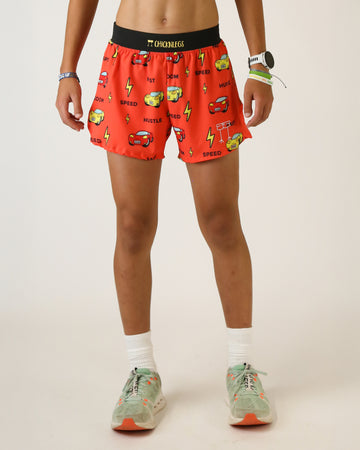 Runner is wearing ChicknLegs in the men's 4 in split running shorts with a back pocket and inner liner pocket. The print has cars on it that are yellow and red, as well as yellow lightning bolts on it with speed, hustle and zoom written on it.