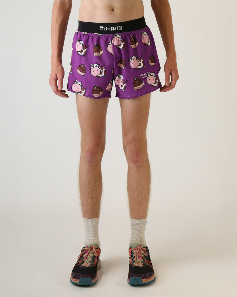 Runner is wearing ChicknLegs in the men's 4 in split running shorts that has a back pocket and inner liner pocket. The print has brown cows on it with chocolate milk. 