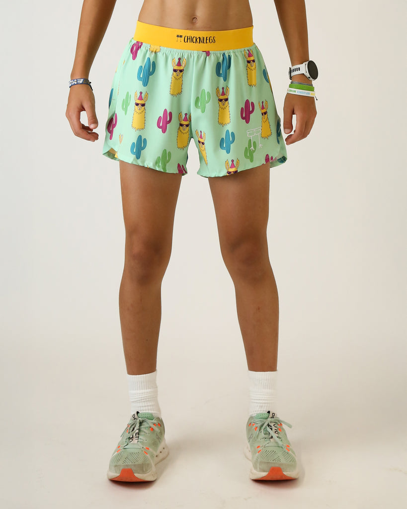 Runner is wearing ChicknLegs in the men's 4 in split running shorts that has a back pocket and inner liner pocket. The print has llamas over t with cactus in green, blue, and red.