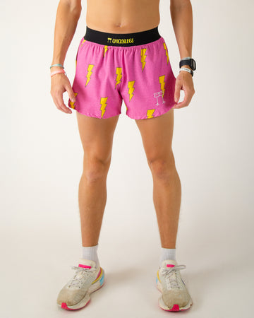 Runner is wearing ChicknLegs in the men's 4 in split running shorts with a back pocket and inner liner pocket. The print has yellow lightning bolts on it with a hot pink background.