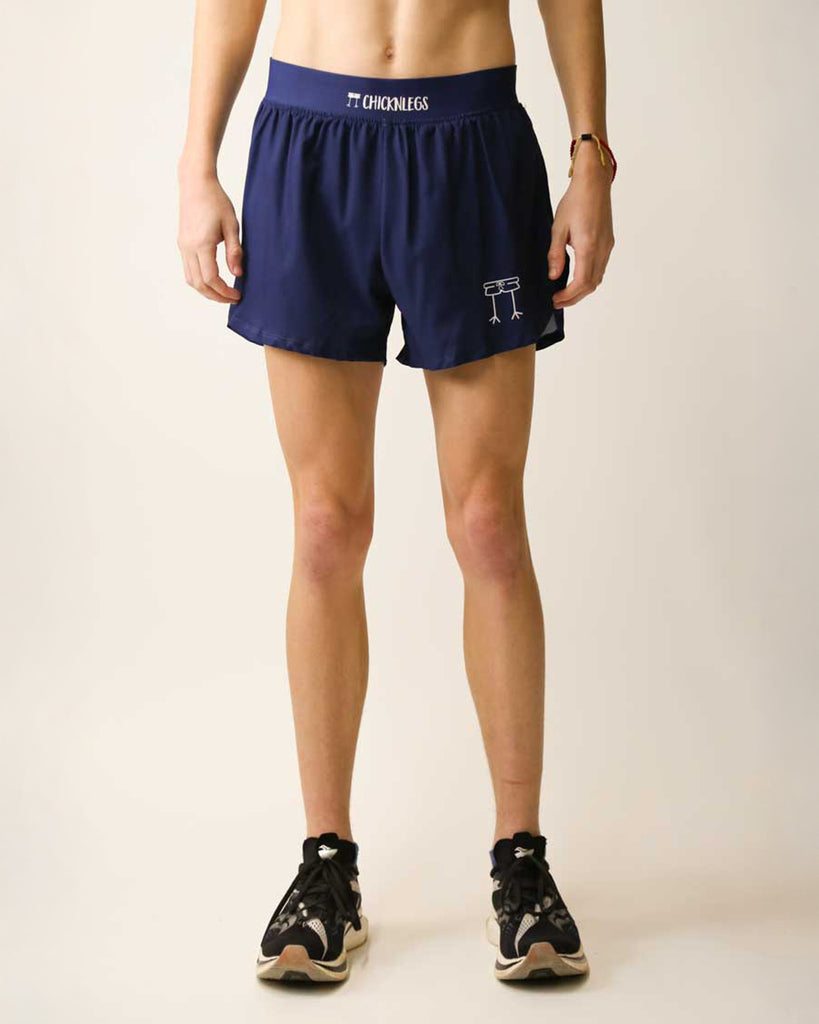 Runner is wearing ChicknLegs in the men's 4 in split running shorts with a back pocket and inner liner pocket. The print is solid navy.