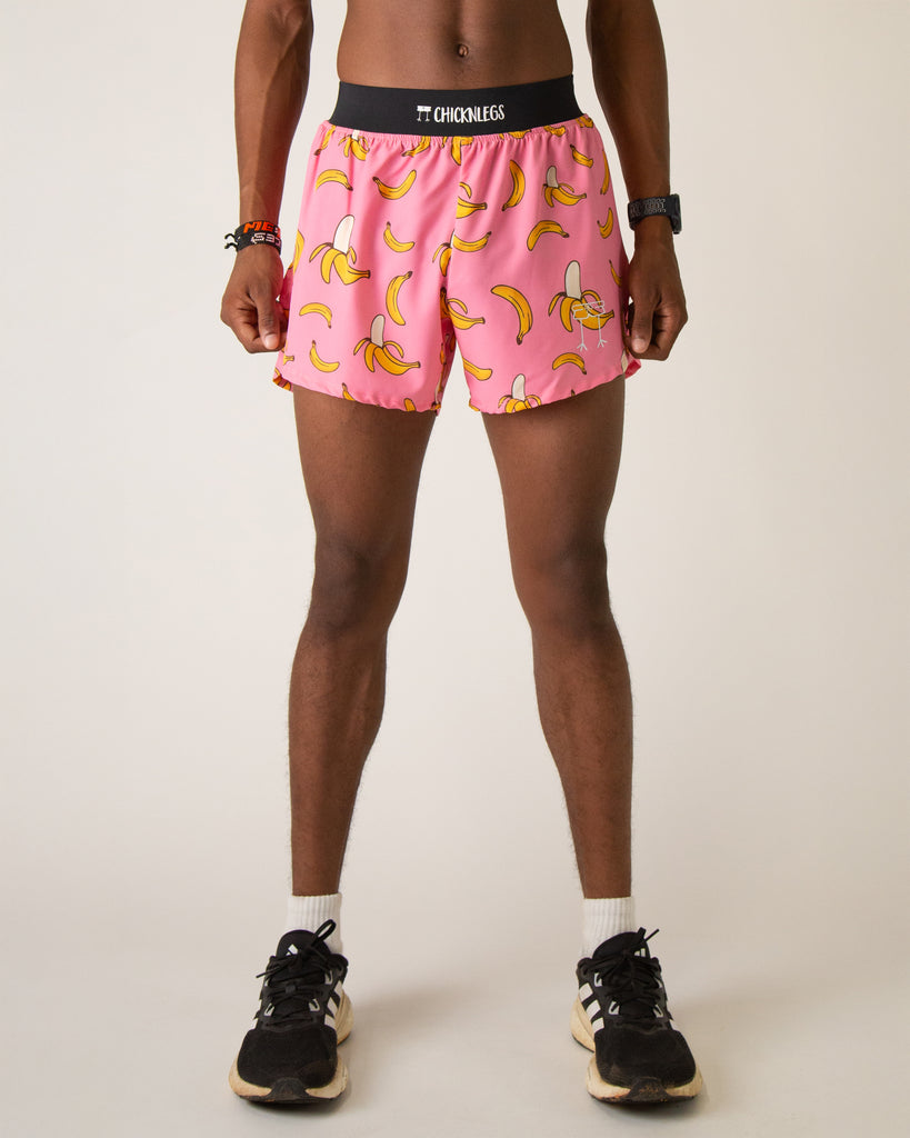 Runner is wearing ChicknLegs in the men's 4 in split running shorts with a back pocket and inner liner pocket. The print has yellow bananas on it on a fun pink background.