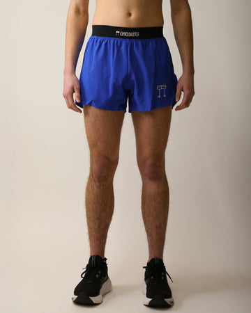 Runner is wearing ChicknLegs in the men's 4 in split running shorts with a back pocket and inner liner pocket. The print is a solid royal blue.