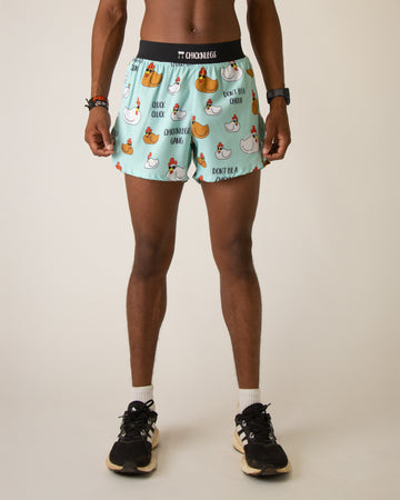 Runner is wearing ChicknLegs in the men's 4 in split running short with a back pocket and inner liner pocket. The print has fun chickens all over it wearing sunglasses that are brown and white on a blue background.