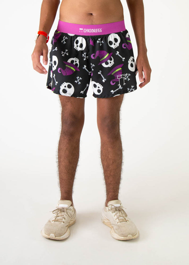 The model is a runner who is wearing Chicknlegs running shorts in the men's 4 inch split runners shorts in the skulls design, facing front.