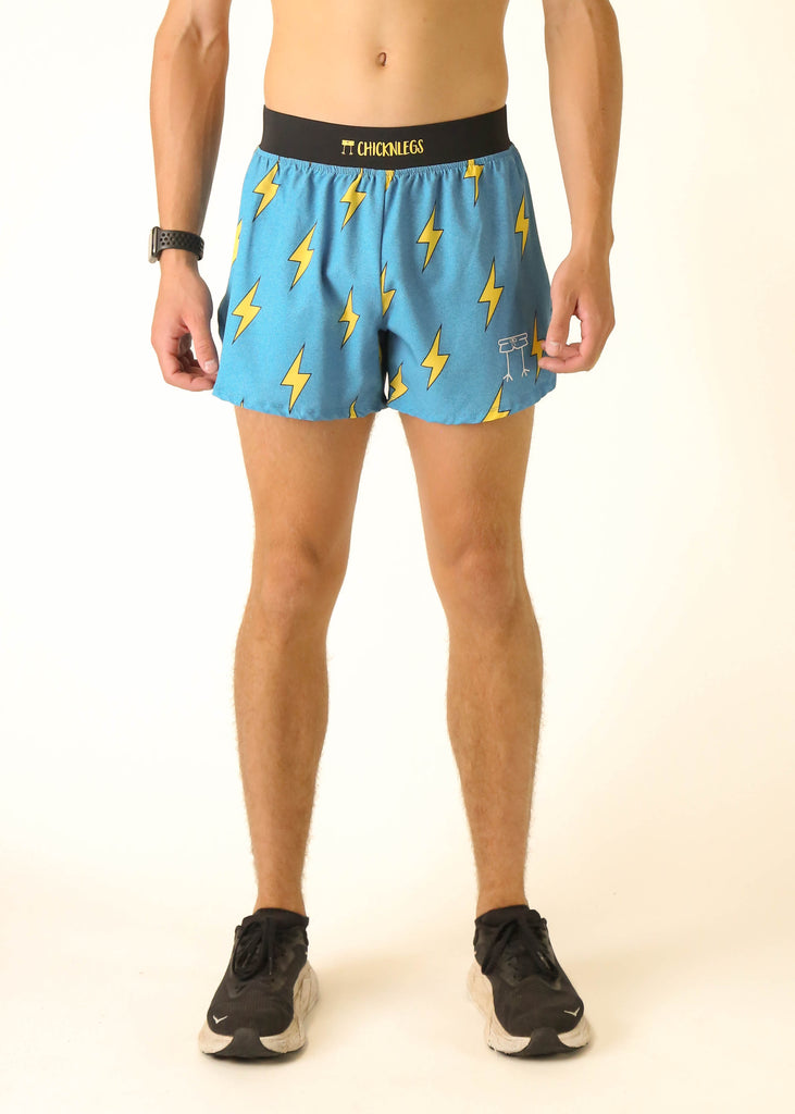 Model wearing Chicknlegs men's 4 inch split running shorts in the blue bolts design facing front.
