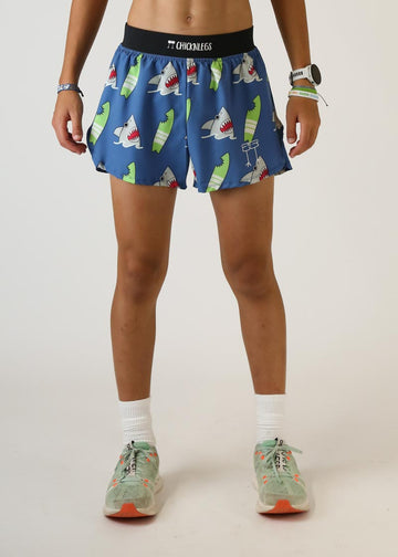 Model wearing Chicknlegs men's 4 inch split running shorts blue shark design front view