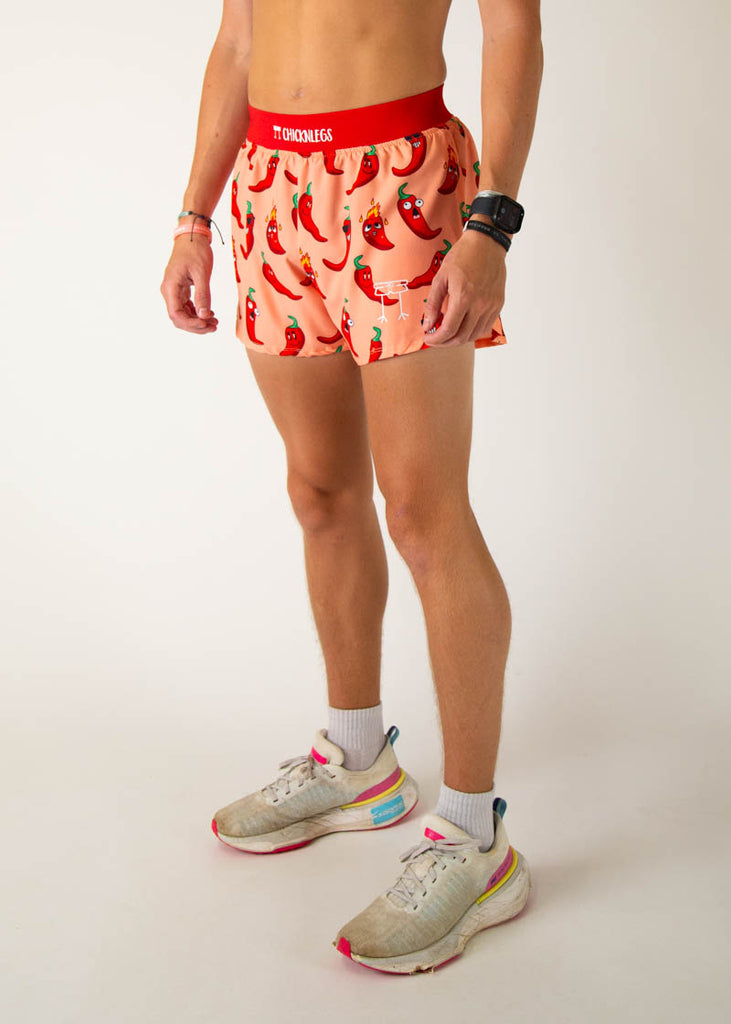 Model is a runner wearing Chicknlegs 4 inch split running shorts in the Chili Pepper design, facing left.
